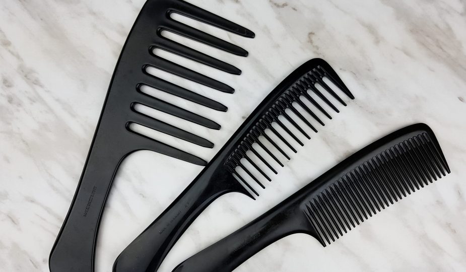 Detangling 4c hair with a comb. The three seamless combs of different widths