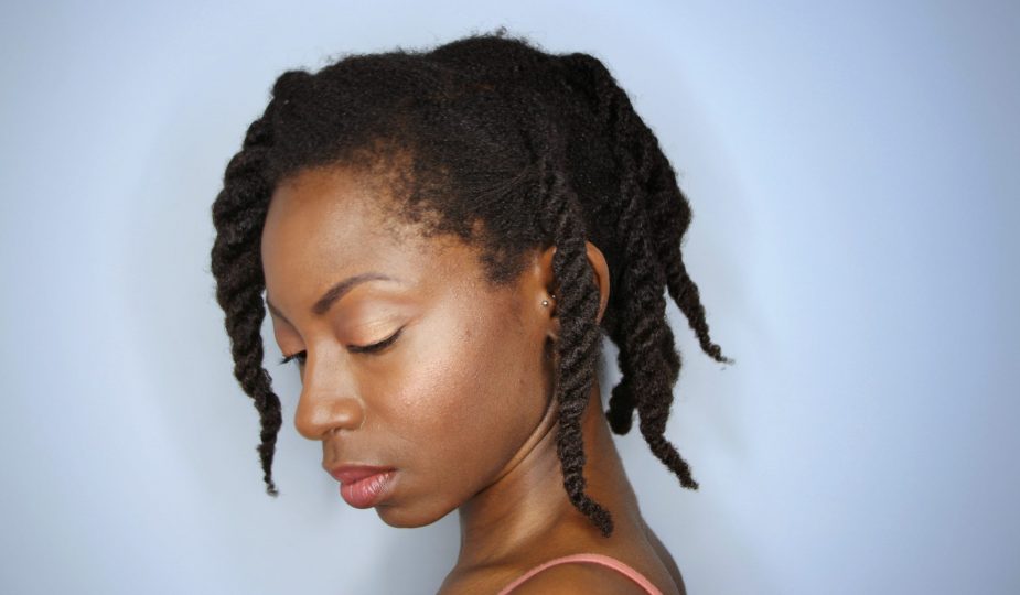 From A to 4z standing in profile showing off completed look of three strand twists on 4c hair