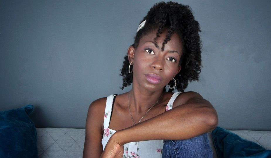 From A to 4z sitting on a sofa with bantu knot out twist out braid out